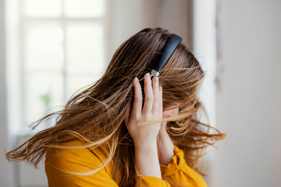Girl dancing to music with headphones on