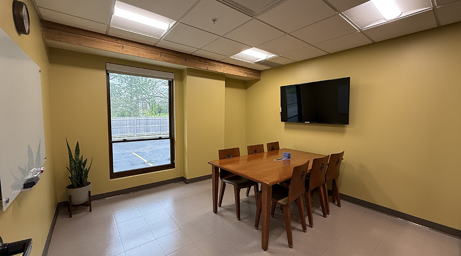 Study Room 2 interior showing a table, six chairs, and a mounted monitor