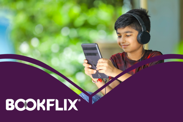 BookFlix resource image showing boy holding a tablet with headphones on