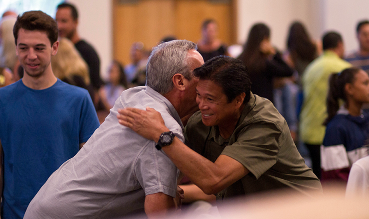 Two men hugging and shaking hands